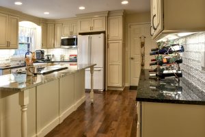 Louisville Kentucky Kitchen Renovation, Hearth and Home, Country Kitchen, Farmhouse Sink, Hardwood Floors, Off-White Cabinets with Taupe Glaze, Scalloped Backsplash, eeded Glass Cabinet Doors, Under-Cabinet Lighting, Granite Countertops, Stainless Steel Appliances, Kitchen Island