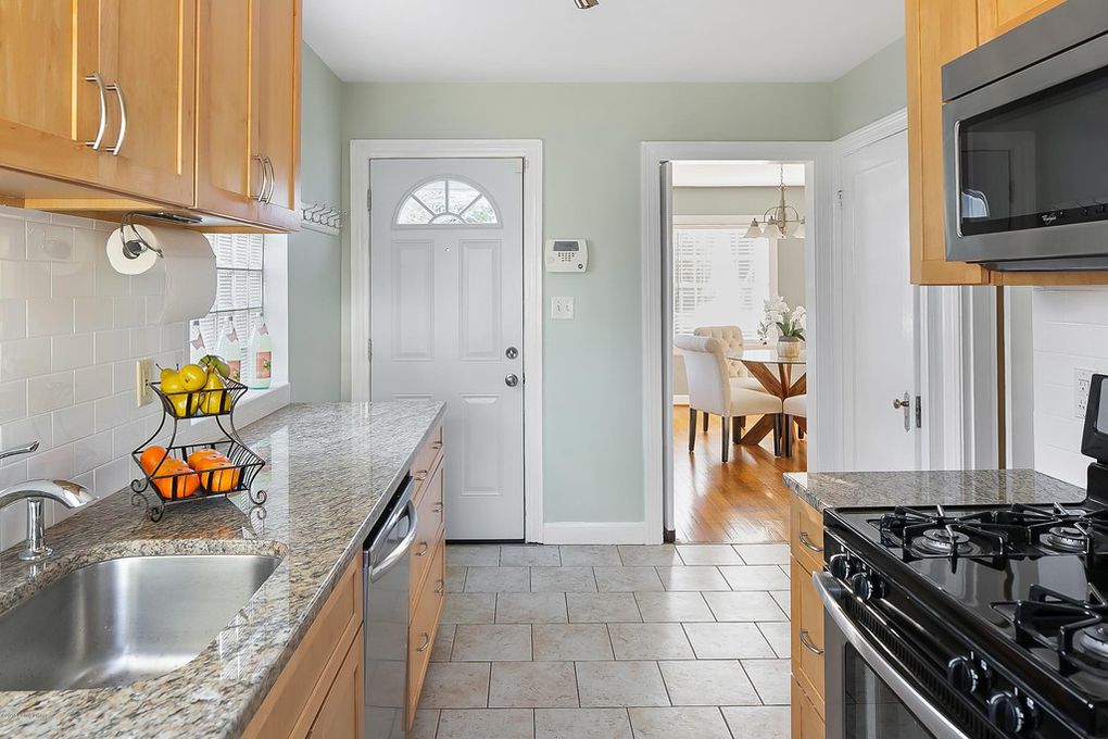 Louisville Kentucky Home Staging, Galley Kitchen, Granite Countertops, Tile Flooring, Stainless and Black Gas Range, Stainless Steel Appliances, Subway Tile, Chrome Fixtures