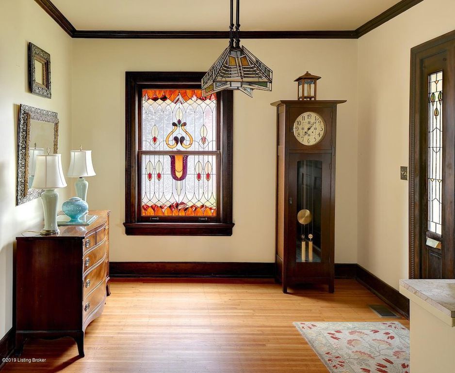 stained glass window, grandfather clock, honey oak hard wood floors, stained glass light fixture